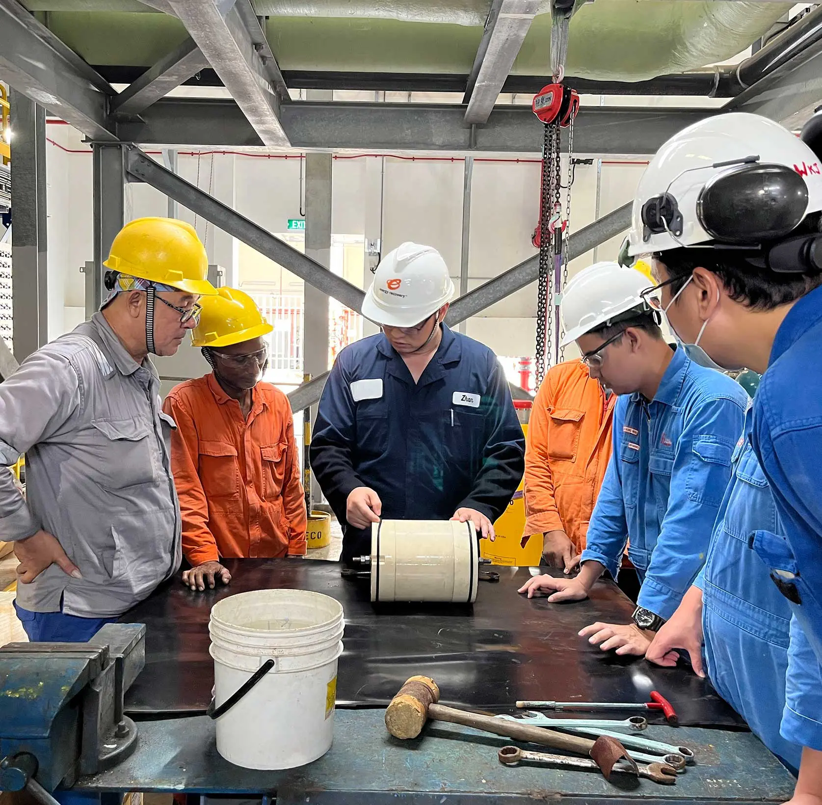 Employees working on a piece of equipment