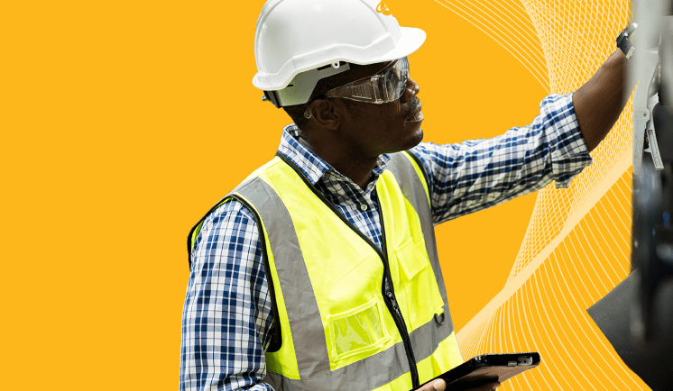 An employee with a hard hat and a neon vest on