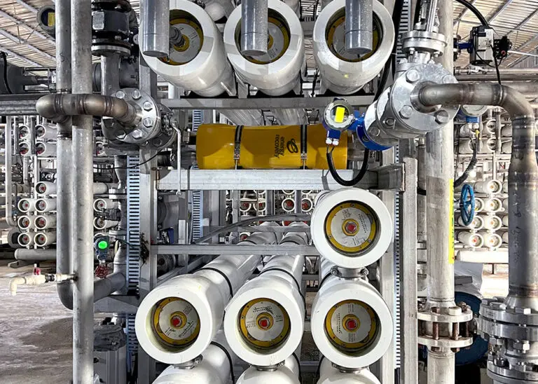 Industrial membrane filtration system with multiple pressure vessels, stainless steel piping, and instrumentation used for high-efficiency wastewater reuse.